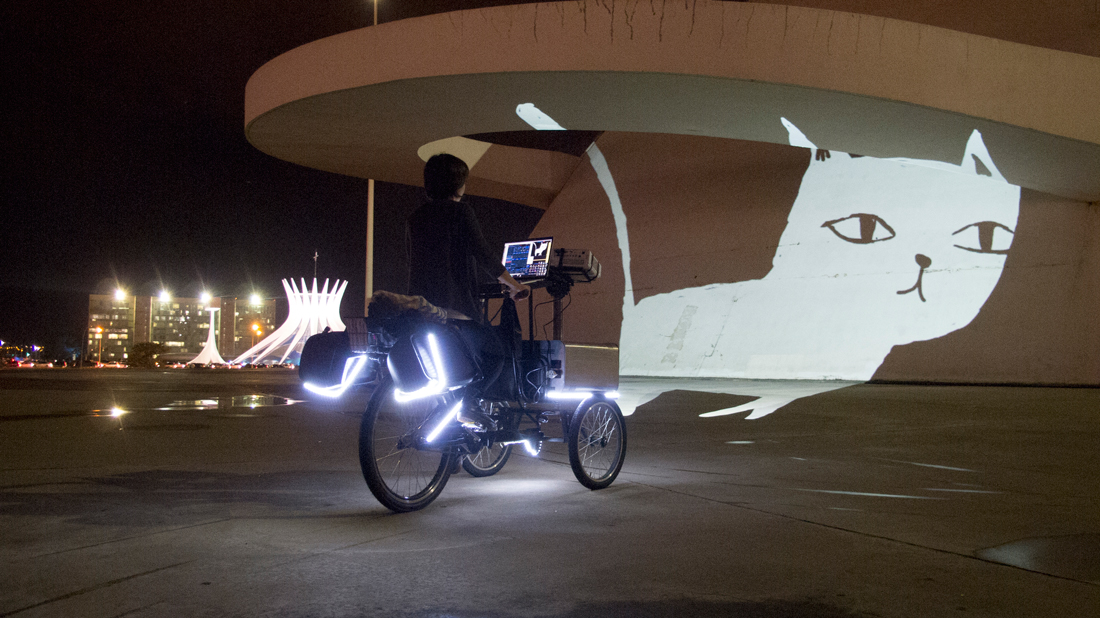 VJ Suave Suaveciclo conducting mobile projection mapping on the walls of the National Museum in Brasilia, Brazil.