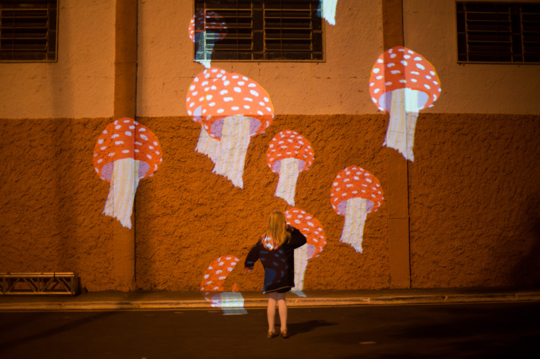 VJ Suave Suaveciclo conducting mobile projection mapping on a city wall