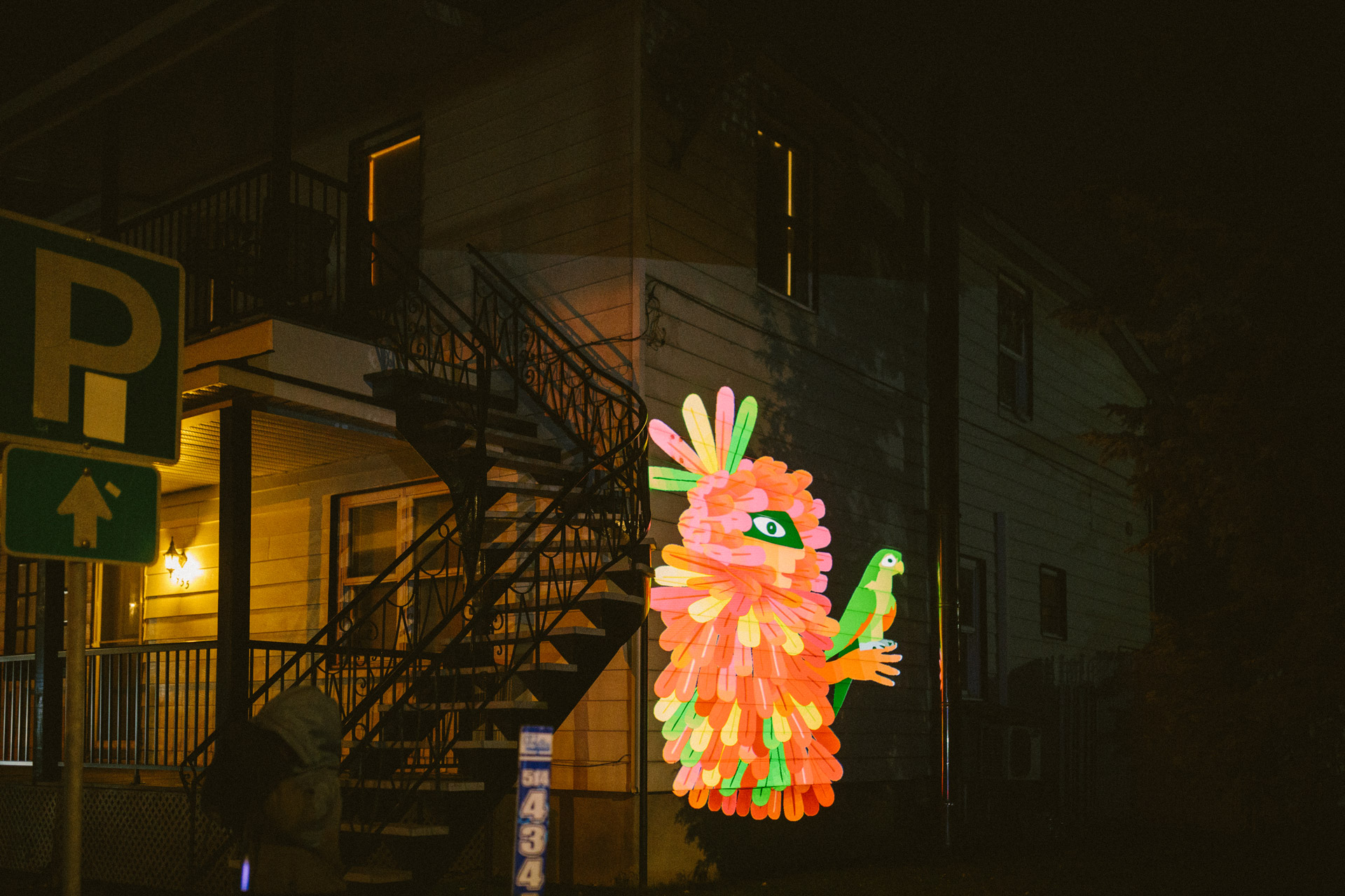 VJ Suave Suaveciclo conducting mobile projection mapping on a city wall