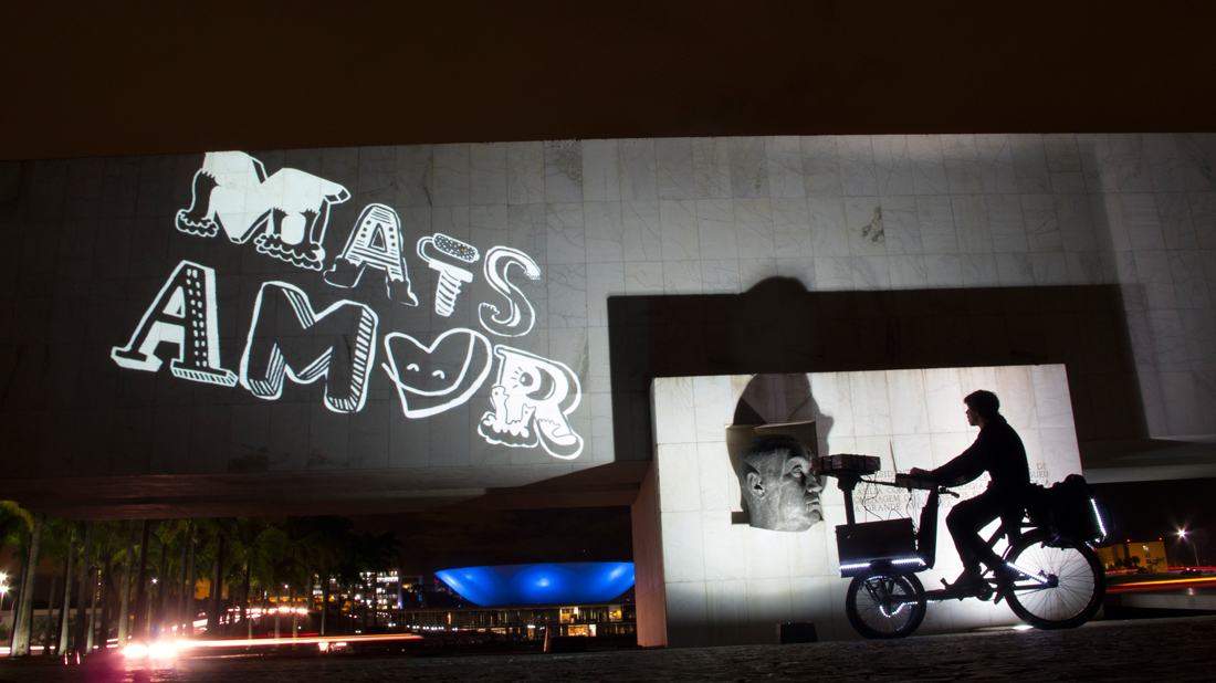 VJ Suave Suaveciclo conducting mobile projection mapping on the walls of Brazilia, Brazil federal capital