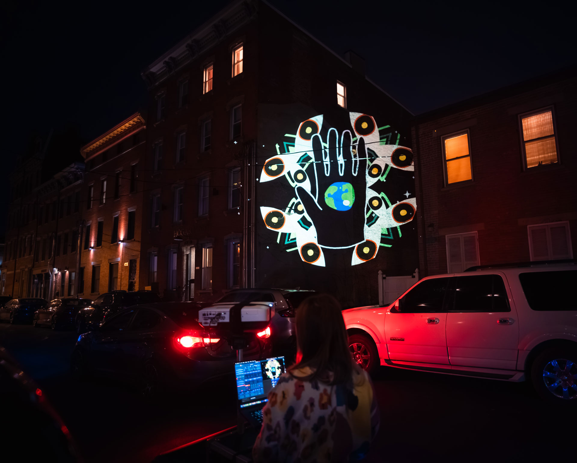 VJ Suave Suaveciclo conducting mobile projection mapping of a kaleidoschopic animated image